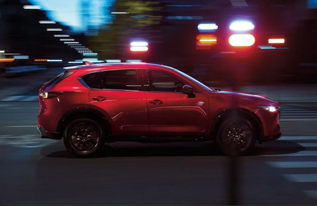 A red Mazda CX-5 driving on a highway near Wooster, Ohio