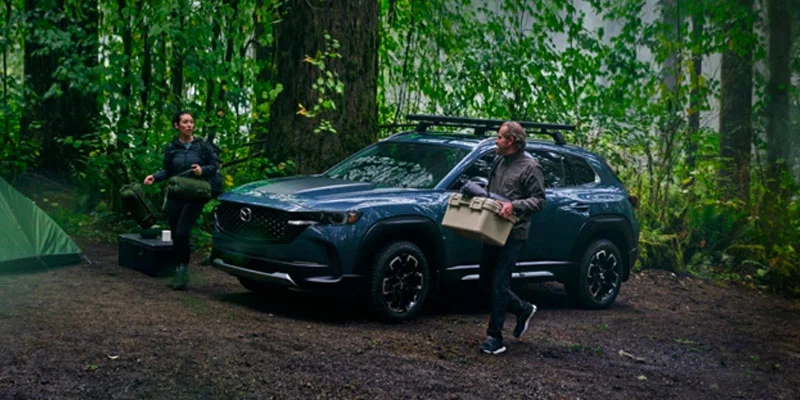 Two people camping with their 2025 Mazda CX-50 